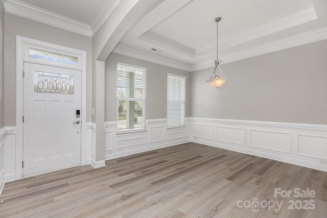 entryway with a wainscoted wall, light wood-type flooring, and visible vents