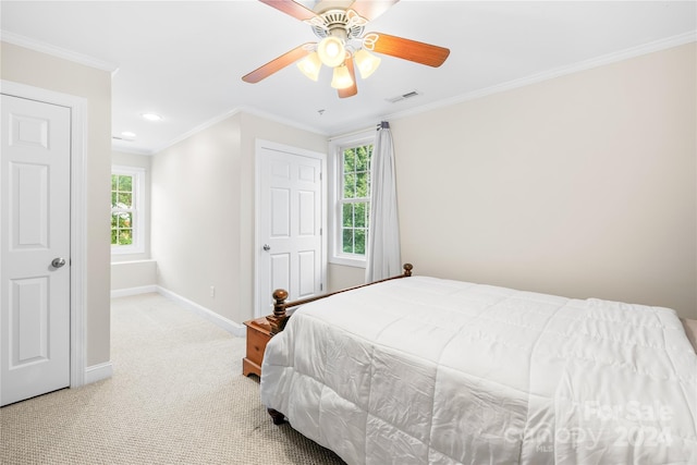 carpeted bedroom featuring ceiling fan and ornamental molding