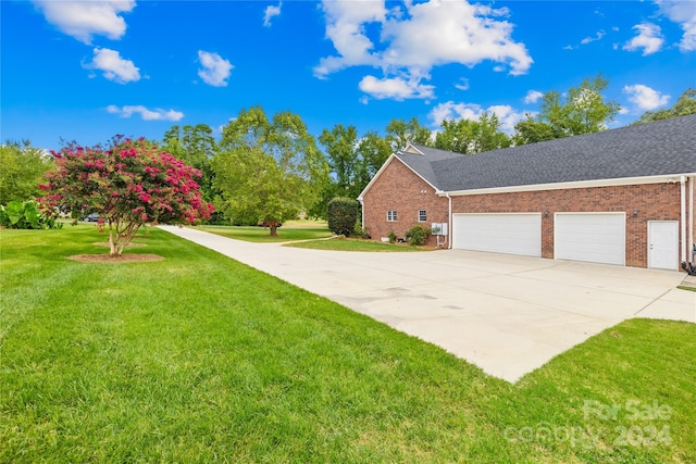 view of home's exterior with a garage and a yard