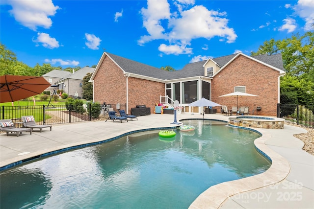 view of pool featuring a pool with connected hot tub, a sunroom, a patio, and fence