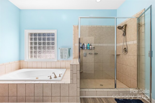 bathroom with a whirlpool tub and a shower stall