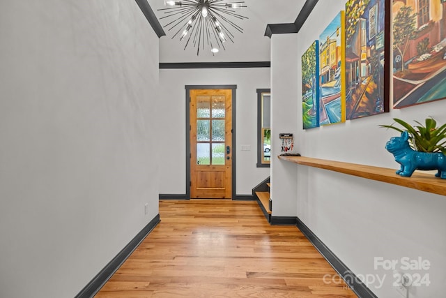 foyer with baseboards, light wood-style flooring, and an inviting chandelier