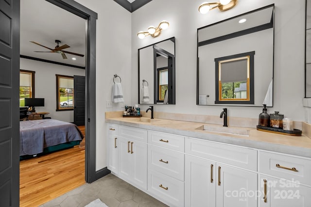 ensuite bathroom with tile patterned flooring, a sink, ensuite bath, and double vanity