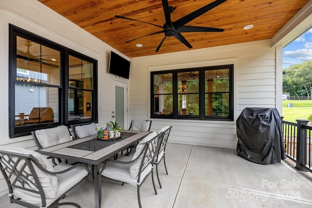 view of patio featuring a ceiling fan, outdoor dining area, and a grill