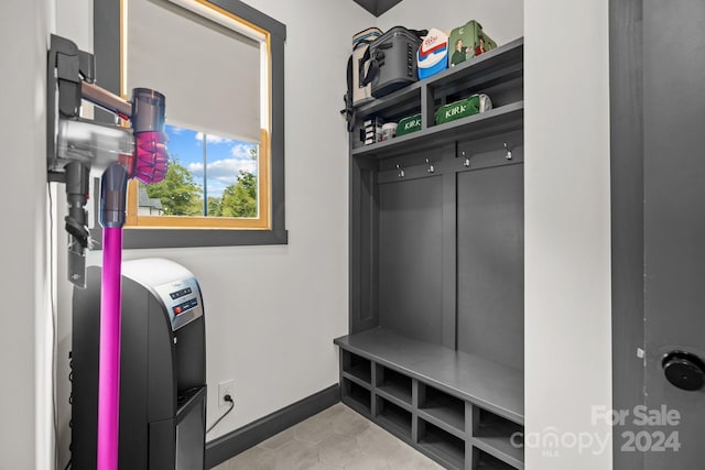 mudroom featuring light tile patterned floors and baseboards