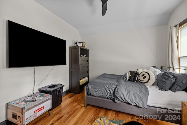 bedroom featuring lofted ceiling, ceiling fan, and light wood finished floors