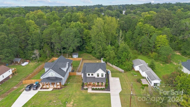 birds eye view of property with a forest view