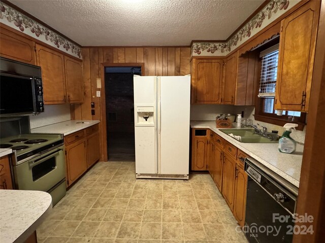 4539 S New Hope Rd, Gastonia, NC 28056 - kitchen with a sink, black appliances, light countertops, a textured ceiling, and brown cabinets