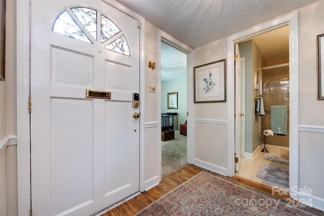 foyer with a textured ceiling and hardwood / wood-style flooring