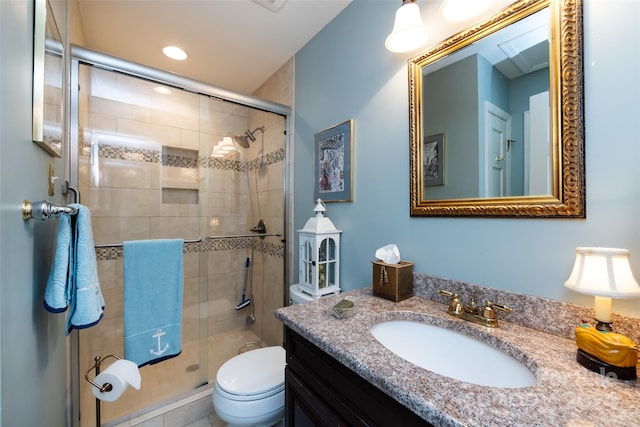 bathroom featuring vanity, toilet, and walk in shower