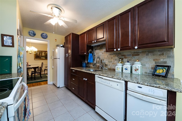 kitchen featuring ceiling fan with notable chandelier, white appliances, light stone countertops, backsplash, and sink