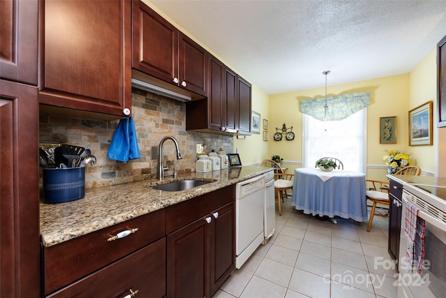 kitchen featuring dishwasher, light stone counters, sink, and decorative backsplash