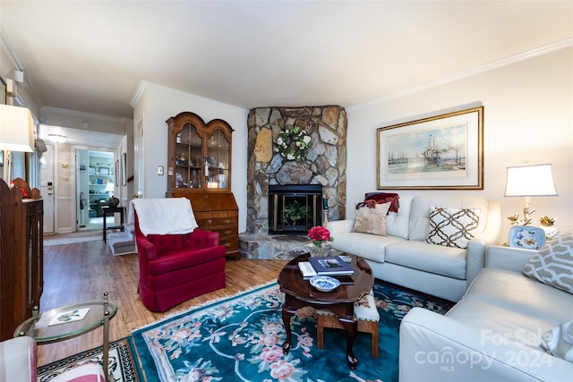 living room with a fireplace, ornamental molding, and wood-type flooring