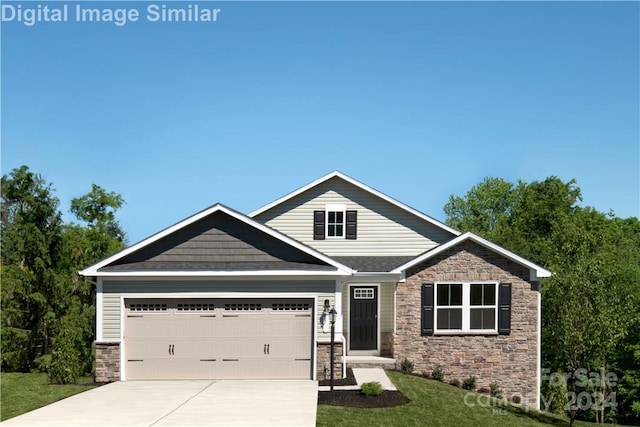 craftsman-style home featuring a garage and a front yard