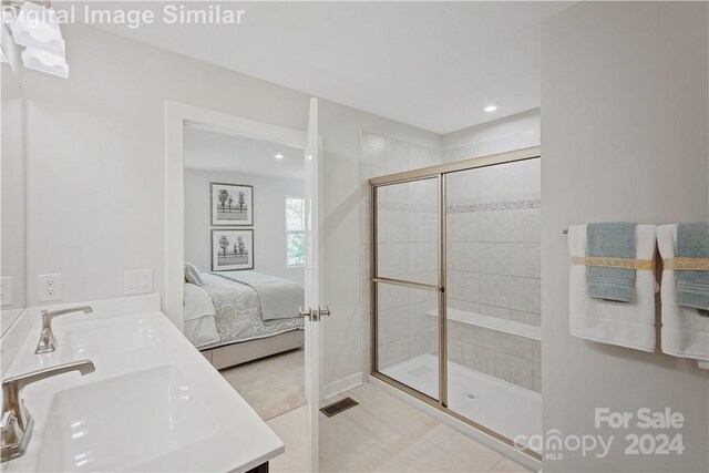 bathroom with tile patterned floors, double sink vanity, and an enclosed shower