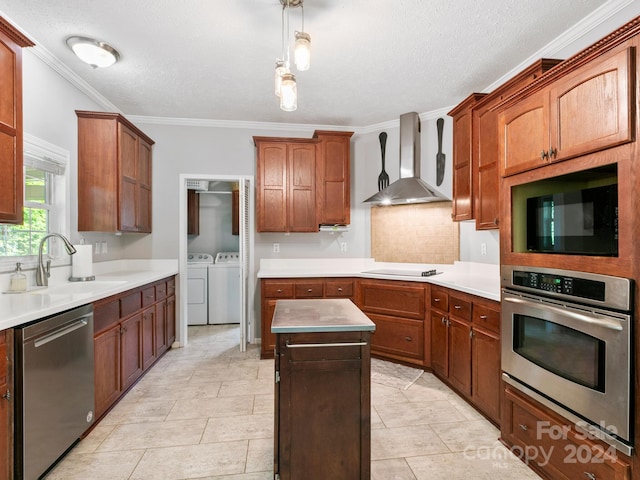 kitchen featuring wall chimney exhaust hood, light tile patterned flooring, black appliances, and washer and dryer