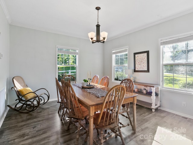 dining area featuring a notable chandelier, ornamental molding, and wood-type flooring