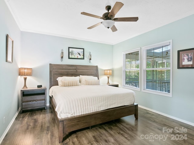 bedroom featuring ceiling fan, crown molding, and dark wood-type flooring