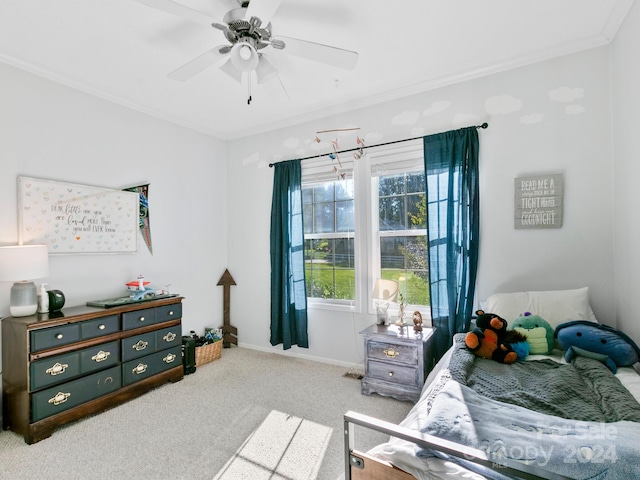 carpeted bedroom with ceiling fan and ornamental molding