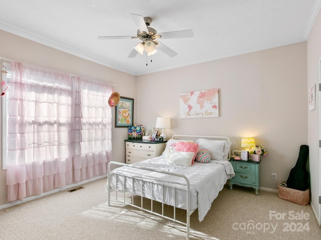 carpeted bedroom with ceiling fan and ornamental molding