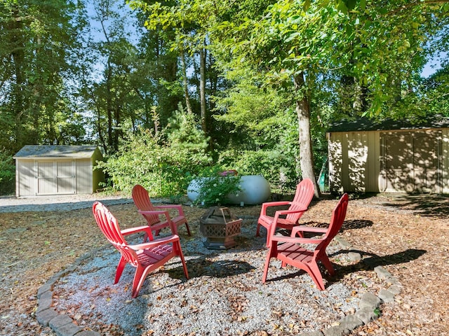 view of yard with an outdoor fire pit and a storage unit