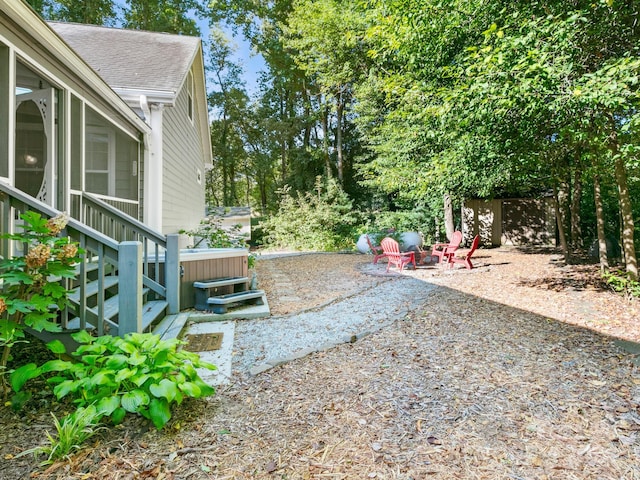 view of yard with a hot tub and a patio area