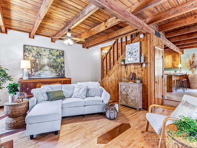 living area with light wood-type flooring, wood ceiling, stairway, and beam ceiling