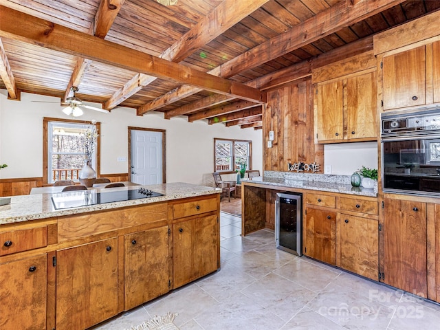 kitchen featuring beverage cooler, black appliances, wooden ceiling, and brown cabinets