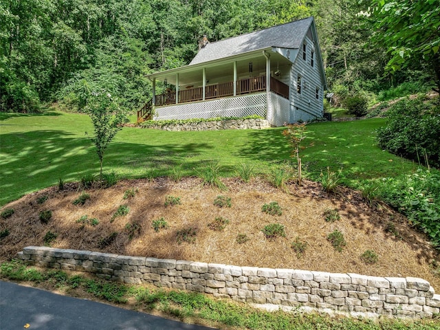 view of front of house with covered porch, crawl space, a front lawn, and a chimney