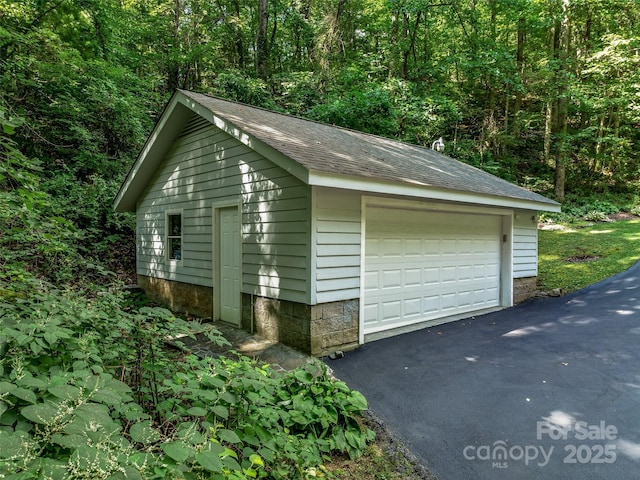 detached garage with a wooded view