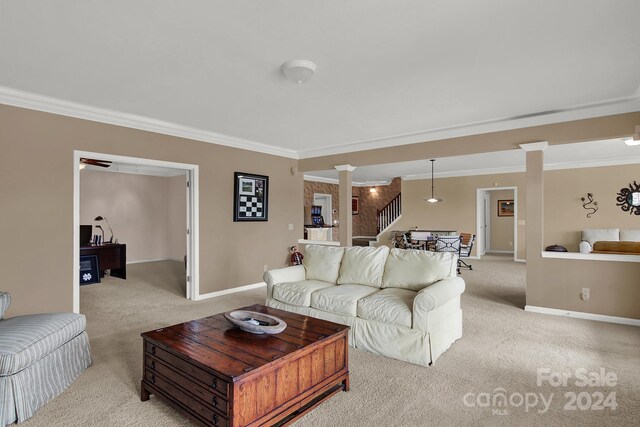 living room featuring ornate columns, ornamental molding, and light colored carpet