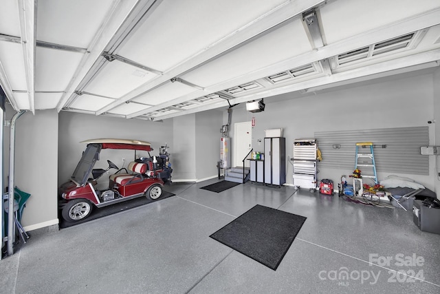 garage featuring water heater and a garage door opener