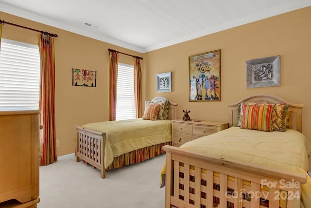 bedroom with crown molding and light carpet