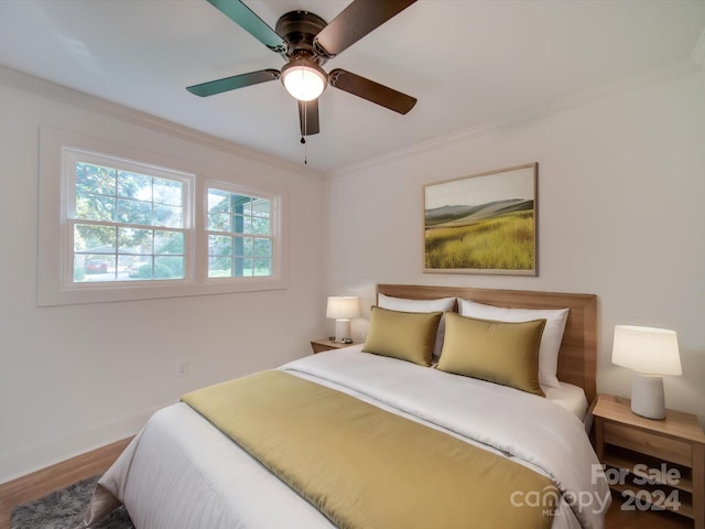 bedroom featuring ceiling fan, crown molding, and wood-type flooring