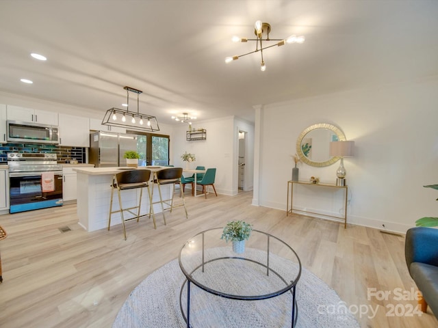 living room with crown molding and light hardwood / wood-style floors