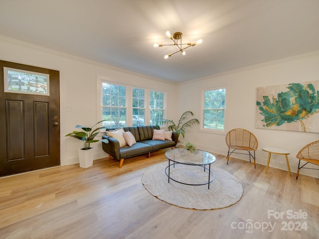 living room with a wealth of natural light, light hardwood / wood-style flooring, and ornamental molding