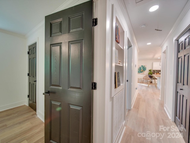 hall featuring light hardwood / wood-style floors and ornamental molding