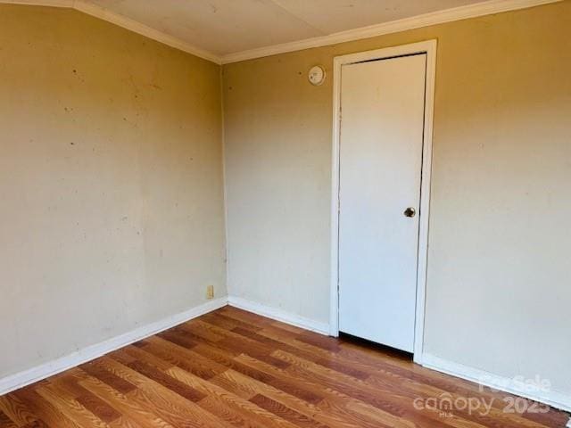 unfurnished room featuring hardwood / wood-style floors and crown molding