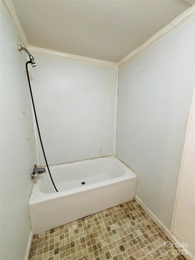 bathroom featuring crown molding and a bath