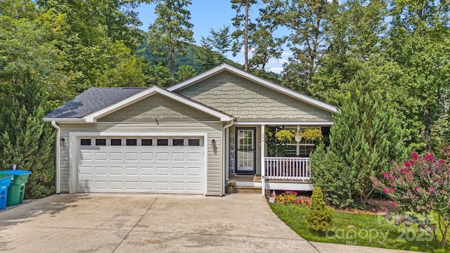 single story home with a garage and covered porch