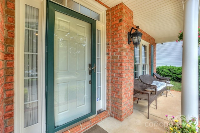 view of exterior entry with a porch