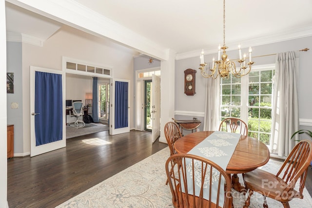 dining area with ornamental molding, a healthy amount of sunlight, a chandelier, and dark hardwood / wood-style flooring