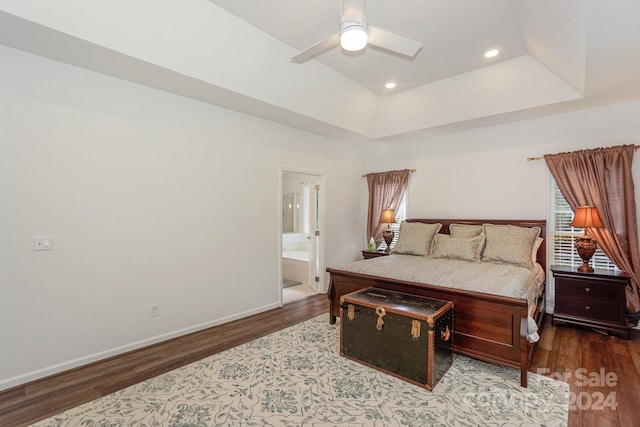 bedroom with wood-type flooring, connected bathroom, and ceiling fan