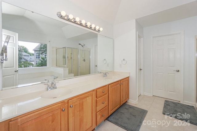 bathroom featuring vanity, plus walk in shower, vaulted ceiling, and tile patterned floors