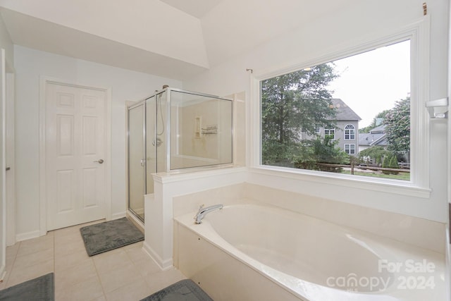 bathroom featuring lofted ceiling, shower with separate bathtub, tile patterned floors, and a healthy amount of sunlight