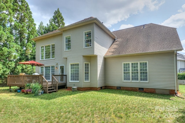 rear view of house with a yard and a deck