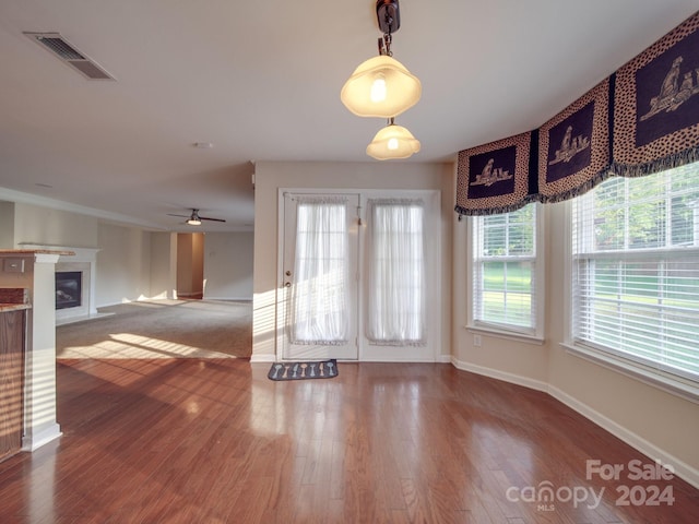 interior space with ceiling fan and wood-type flooring