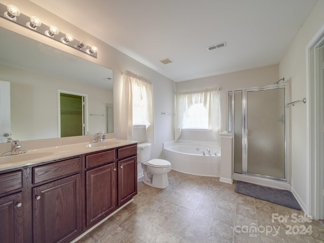 full bathroom featuring separate shower and tub, toilet, dual bowl vanity, and tile patterned floors