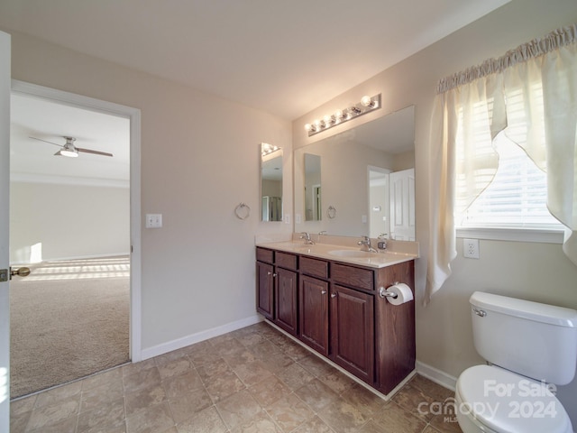 bathroom with tile patterned flooring, ceiling fan, toilet, and double sink vanity