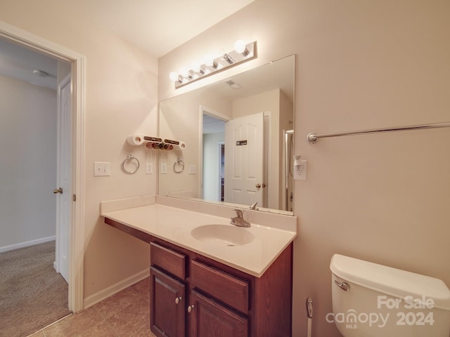 bathroom with tile patterned flooring, toilet, and vanity